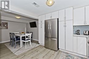 Mississauga (Applewood) apartment for rent - A kitchen with a refrigerator, table and chairs.