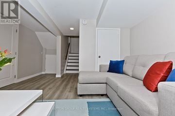 Mississauga (Applewood) apartment for rent - A living room with a grey couch and a glass table.
