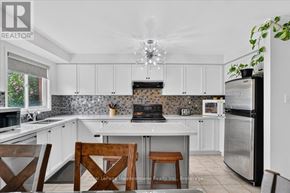 Milton (De Dempsey) apartment for rent - A kitchen with a white counter top and a wooden chair.