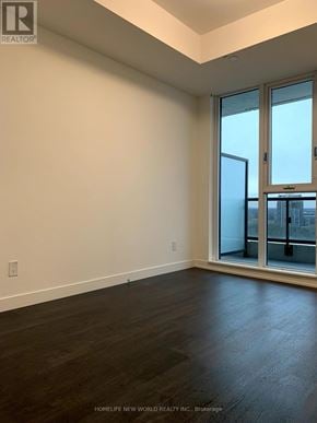 Markham (Unionville) condo for rent - A room with a large window and wooden flooring.