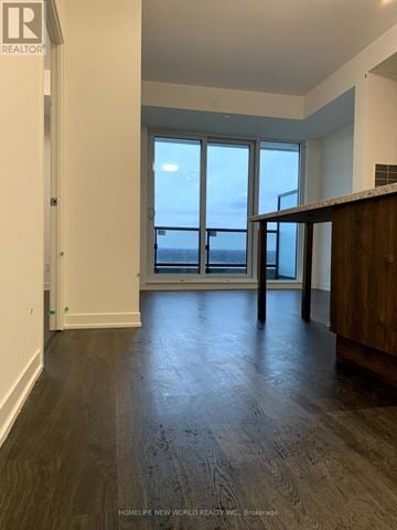 Markham (Unionville) condo for rent - A spacious room with wooden flooring and large windows overlooking the water.