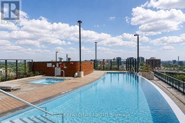 Toronto (Church-Yonge Corridor) condo for rent - A swimming pool with a view of the city in the background.