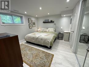 Toronto (Lansing-Westgate) apartment for rent - A bedroom with a bed, nightstands, and a rug.