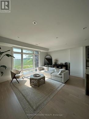 Vaughan (Kleinburg) townhouse for rent - A living room with a white sofa and a large window.