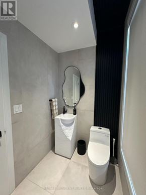 Vaughan (Kleinburg) townhouse for rent - A bathroom with a toilet, sink, and mirror.