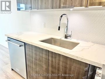 Toronto (Mimico) condo for rent - A modern kitchen with a sink and a dishwasher.