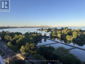 Toronto (Mimico) condo for rent - A view of a city from a high vantage point with a body of water in the foreground.