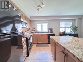 Hamilton (Hamilton Beach) townhouse for rent - A kitchen with wooden cabinets and granite countertops.