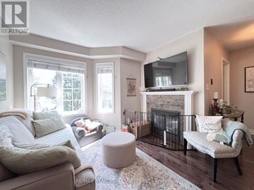 Hamilton (Hamilton Beach) townhouse for rent - A living room with a fireplace and a television on the wall.