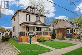Welland (Broadway) apartment for rent - A house with a well-maintained lawn and a clear sky in the background.