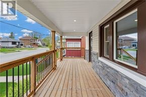 Welland (Broadway) apartment for rent - A wooden deck with a railing and a view of a residential street.