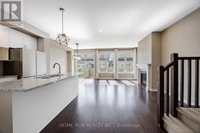 Ottawa townhouse for rent - A spacious living room with a staircase on the right side.