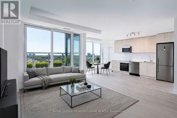 Toronto (Clairlea-Birchmount) condo for rent - A modern living room with a glass coffee table and a grey sofa.