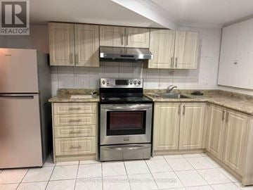 Markham (Middlefield) apartment for rent - A kitchen with a stove top oven and a refrigerator.