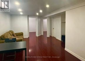 Markham (Middlefield) apartment for rent - A room with a brown couch and a black table.