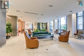Mississauga (Central Erin Mills) condo for rent - A spacious waiting area with brown chairs and a green couch.