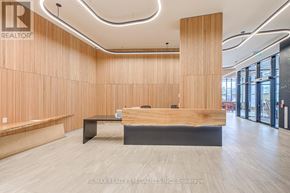 Mississauga (Central Erin Mills) condo for rent - A modern office space with wooden paneling and a reception desk.