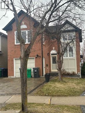 Mississauga (Meadowvale) apartment for rent - A red brick house with a tree in front.
