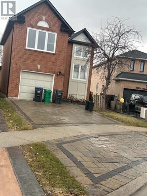Mississauga (Meadowvale) apartment for rent - A house with a driveway and a garage door.