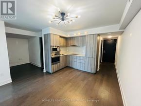Toronto (Bay Street Corridor) condo for rent - A well-lit, spacious kitchen and living area with wooden flooring and a modern design.