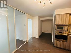 Toronto (Bay Street Corridor) condo for rent - A kitchen area with a stove top oven and microwave.