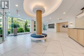 Toronto (Waterfront Communities) condo for rent - A reception area with a large pillar and a bench.