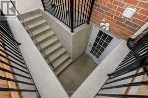 Milton (Be Beaty) apartment for rent - A set of stairs with a metal railing and a brick wall.