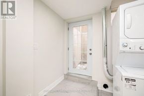 Milton (Be Beaty) apartment for rent - A white washing machine is in a small room with a door.