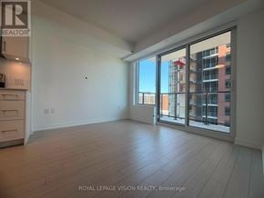 Toronto (Humber Heights) condo for rent - A spacious room with a large window and sliding glass doors.