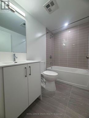 Toronto (Humber Heights) condo for rent - A white bathroom with a toilet, sink, and tub.