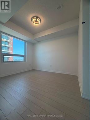 Toronto (Humber Heights) condo for rent - A room with a large window and wooden flooring.