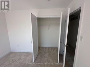 Guelph (Clairfields/Hanlon Business Park) townhouse for rent - A room with a carpeted floor and a doorway leading to another room.