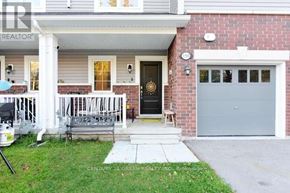Shelburne townhouse for rent - A house with a grey garage door and a black door with a gold handle.