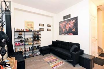 Shelburne townhouse for rent - A black sofa sits in a living room with a shoe rack and a rug.