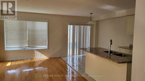 Haldimand townhouse for rent - A kitchen with a counter and a window with blinds.