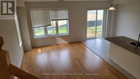 Haldimand townhouse for rent - A room with a wooden floor and a large window with blinds.
