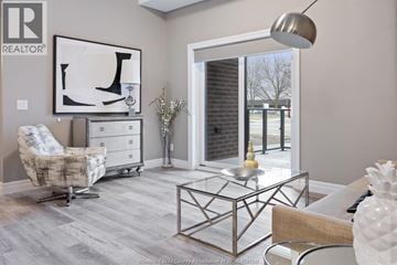 Tecumseh condo for rent - A living room with a glass coffee table and a chair.