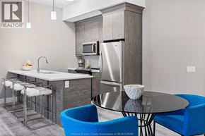 Tecumseh condo for rent - A modern kitchen with a table and chairs.