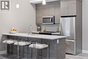 Tecumseh condo for rent - A modern kitchen with a stainless steel refrigerator and a white countertop.