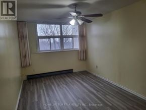 Toronto (Tam O'shanter-Sullivan) condo for rent - A room with a ceiling fan and a window with curtains.