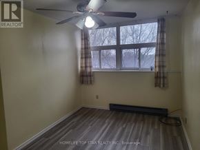 Toronto (Tam O'shanter-Sullivan) condo for rent - A room with a ceiling fan and a window with curtains.