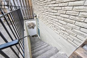 Mississauga (Clarkson) apartment for rent - A staircase with a metal railing and a brick wall.