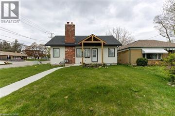 Kitchener apartment for rent - A house with a white front yard and a brown roof.