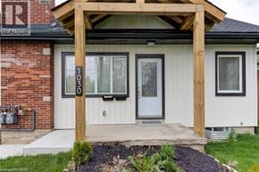 Kitchener apartment for rent - A house with a white door and a wooden porch.