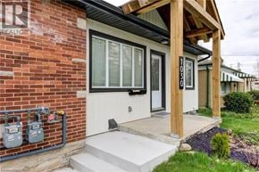 Kitchener apartment for rent - A house numbered 1030 is shown with a white door and a brick wall.