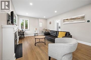 Kitchener apartment for rent - A living room with a grey sofa and a grey armchair.