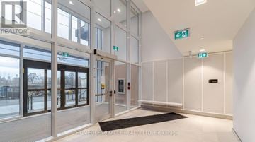 Toronto (Islington-City Centre West) condo for rent - A modern kitchen with a dining table set for two.
