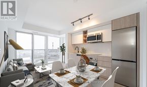 Toronto (Islington-City Centre West) condo for rent - A bedroom with a large bed, a chair, and a painting on the wall.