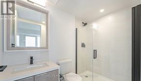 Toronto (Islington-City Centre West) condo for rent - A bedroom with a large bed and a red blanket.
