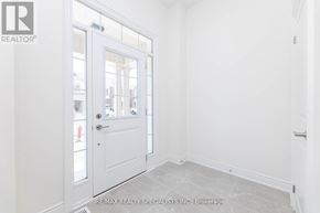 Brampton (Bram West) townhouse for rent - A white door with a glass window is in a room with white walls.